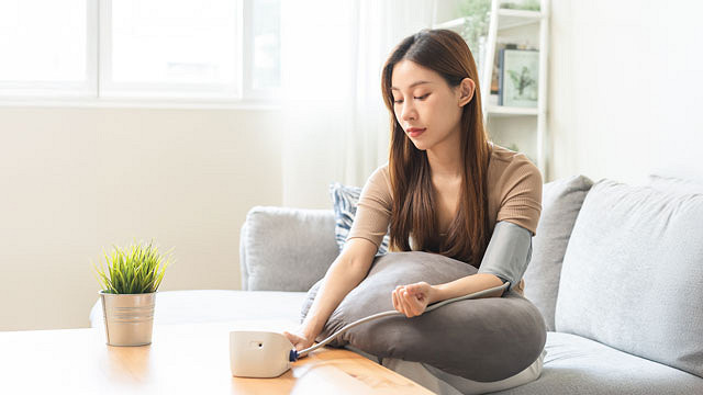 Woman Taking Blood Pressure